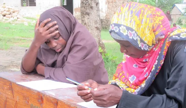 Student doing a an oral literacy exam at Mwambara Primary school